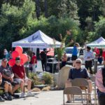 Image of attendees and booths at the event.