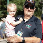 Veteran posing with small child.