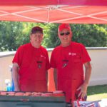 Volunteers Tom Wrightson and Dennis Follain grilling burgers for attendees.