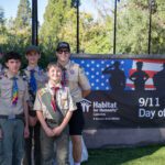 Boy Scout Troop posing in front of 9/11 Day of Service Banner.