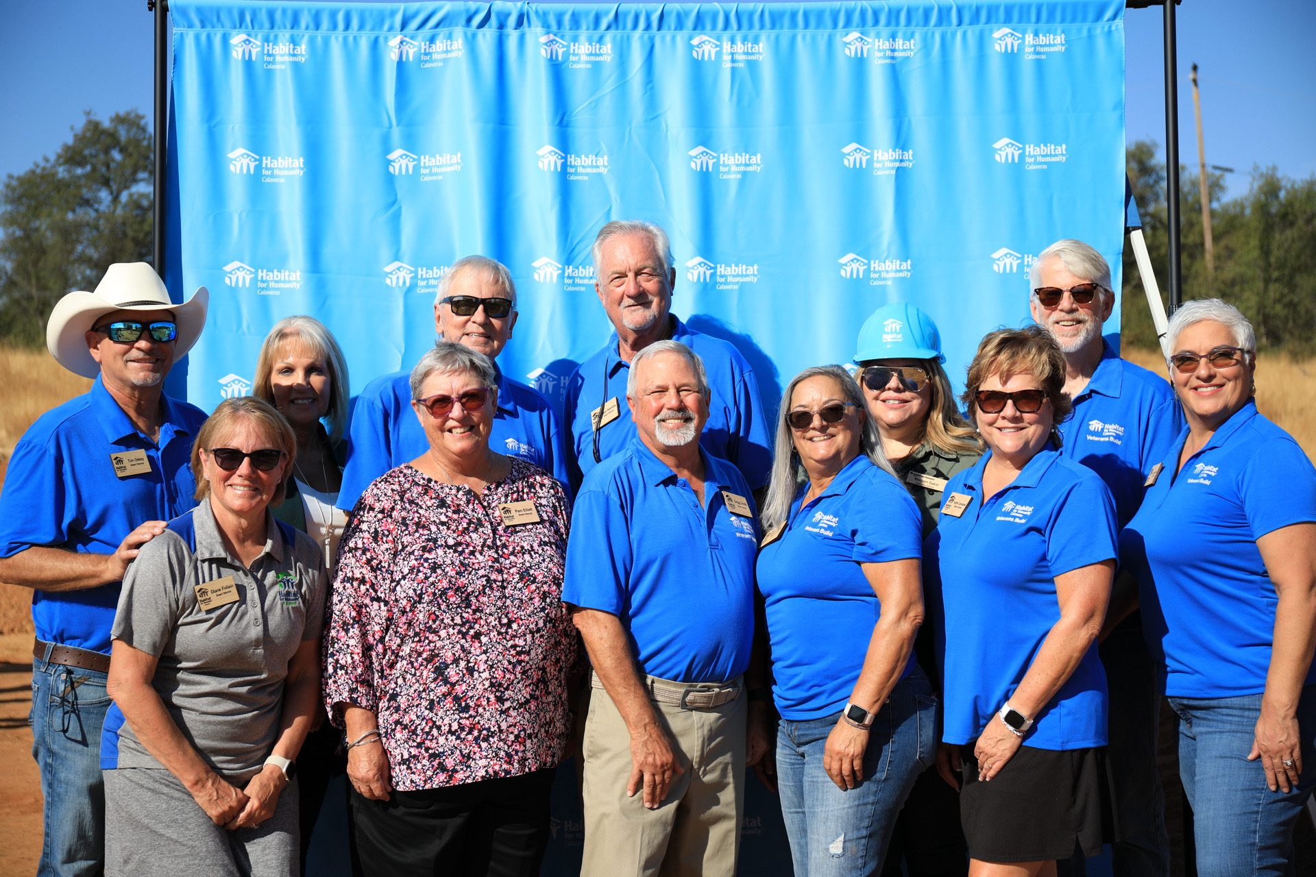 Board members posing in front of backdrop.