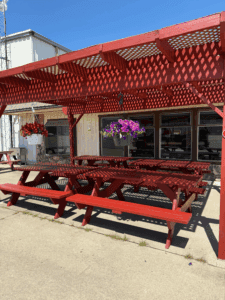 Newly painted awning and picnic tables with flowers donated by Hilltop Market.