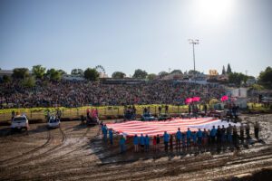 Picture of Habitat for Humanity Calaveras carrying out the flag for the Flag Ceremony.