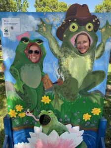 Resource Development Manager Emily Dondero and Volunteer Lisa posing at the frog booth.