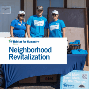 Volunteers posing at booth with Habitat for Humanity Calaveras logo "Neighborhood Revitalization"