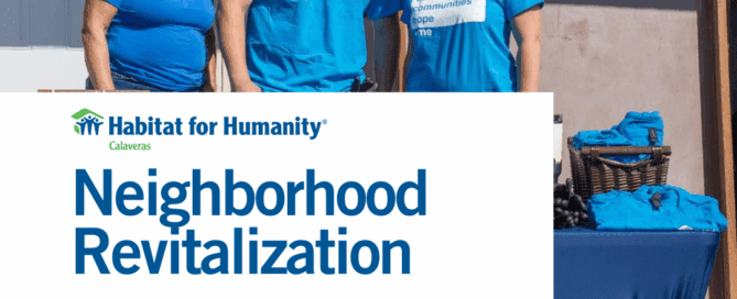 Volunteers posing at booth with Habitat for Humanity Calaveras logo "Neighborhood Revitalization"