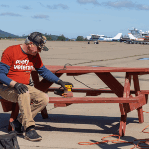 Volunteer sanding picnic table at the San Andreas Airport.