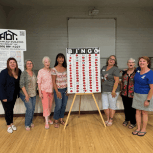 Soroptimist International of Calaveras County posing with Bingo Board.