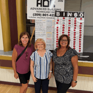 Lisa, Marilyn, and Patrice posing with Bingo Board.